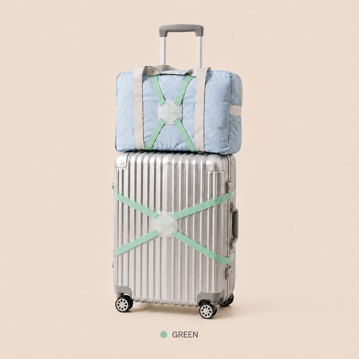 ScandiHome green X-cross luggage strap securing a silver suitcase and travel bag