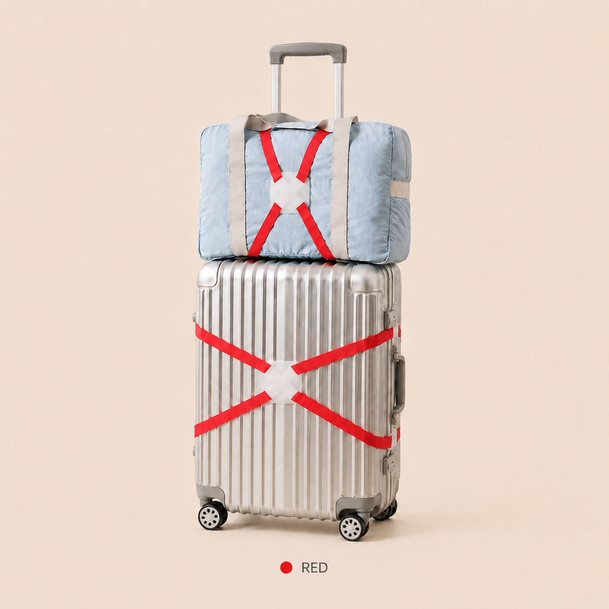 ScandiHome red X-cross luggage strap securing a silver suitcase and travel bag