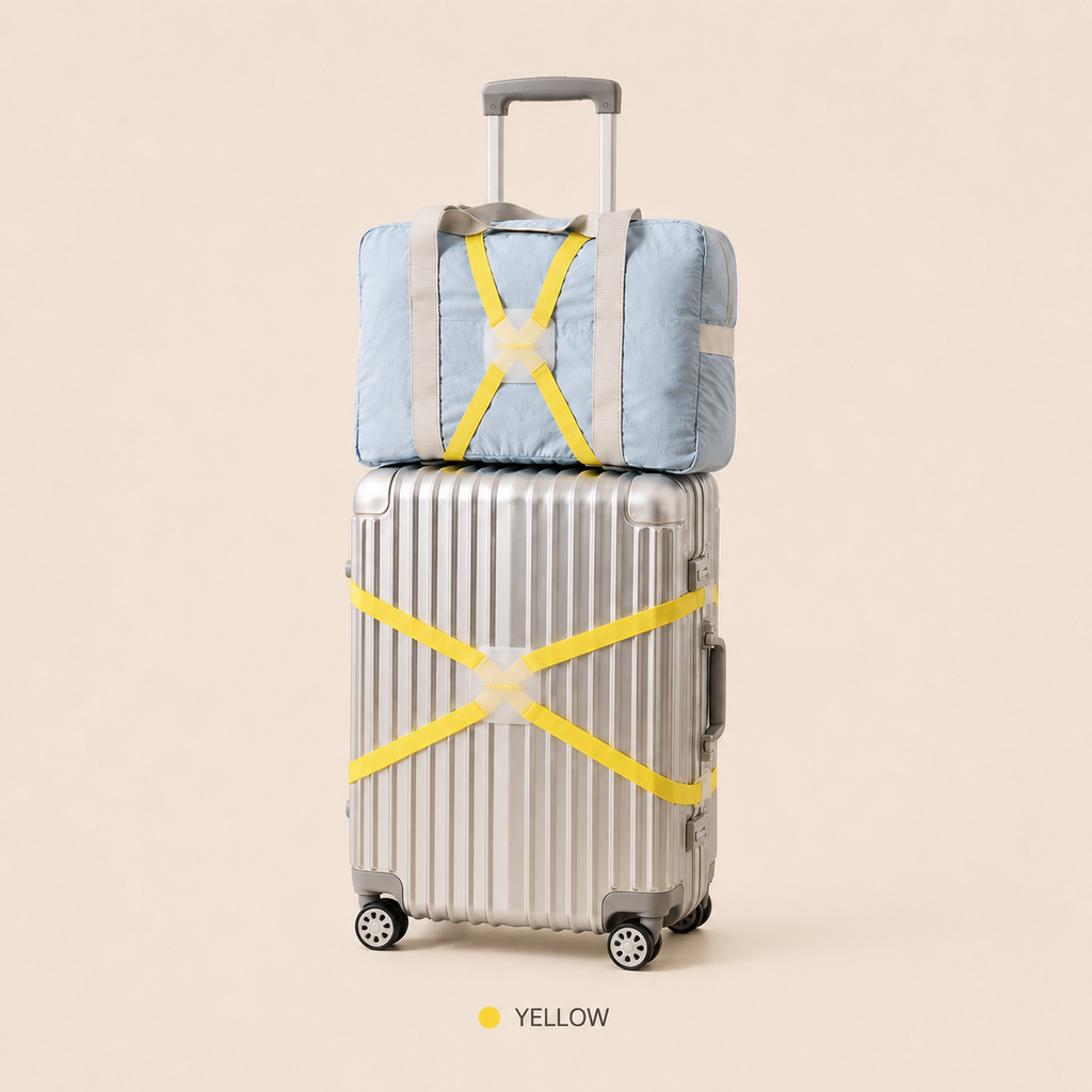 ScandiHome yellow X-cross luggage strap securing a silver suitcase and travel bag
